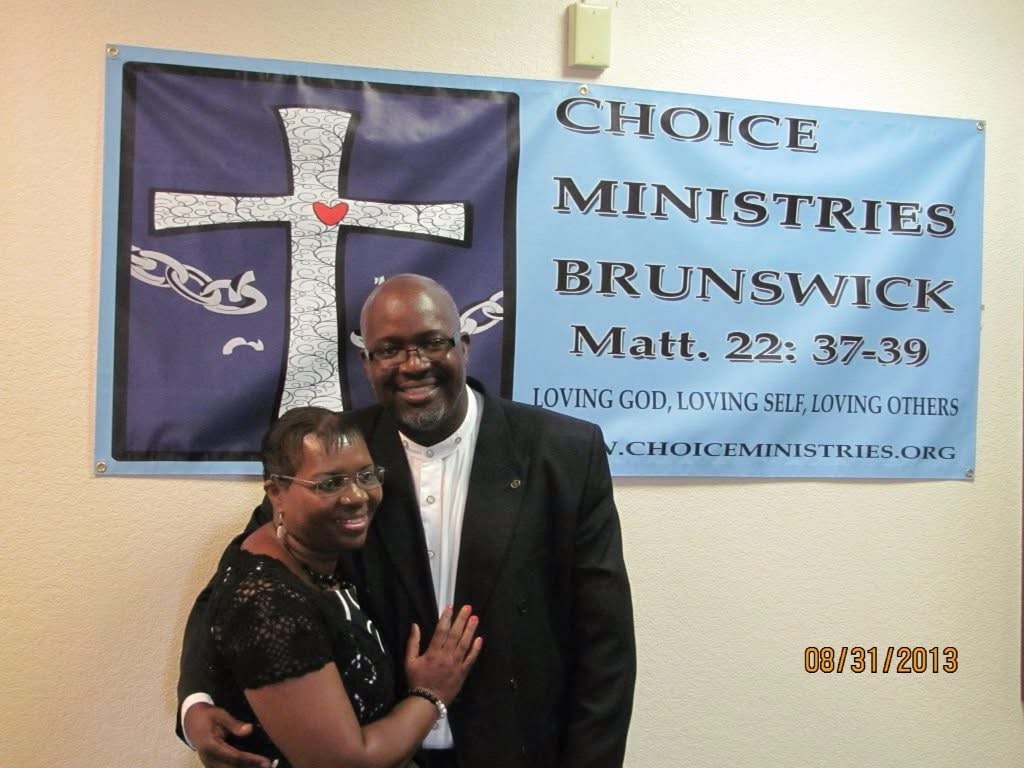 Choice Ministries Brunswick – couple in front of ministry banner